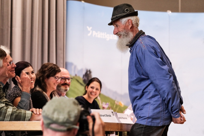 Teilnehmer Alpenbarttreffen vor Jurytisch (© Kellermedia, Grüsch) Teilnehmer Alpenbarttreffen präsentiert sich vor dem Jurytisch