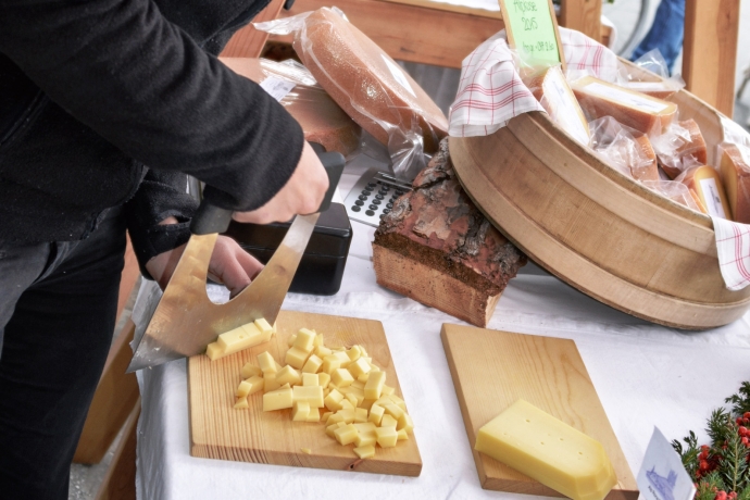Junge Bäuerin rüstet Alpkäse (© Kellermedia, Grüsch) Junge Bäuerin rüstet Alpkäse für die Verkostung.